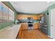 Bright kitchen features wood cabinets, stainless steel appliances and an eat-in area with natural light at 7745 Grant St, Denver, CO 80229