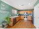 Functional kitchen features stainless steel appliances, wood cabinets, and a hardwood floor at 7745 Grant St, Denver, CO 80229