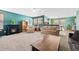 Open-concept living room featuring a fireplace and a large window at 7745 Grant St, Denver, CO 80229