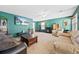Cozy living room with plush carpet, a fireplace, comfortable seating, and a ceiling fan at 7745 Grant St, Denver, CO 80229