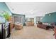 Spacious living room boasts large windows, a fireplace, and carpeted floors throughout at 7745 Grant St, Denver, CO 80229