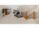 Finished basement area with exercise equipment, entertainment center, and stairs at 2627 E Willamette Ln, Greenwood Village, CO 80121