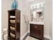 Stylish powder room with modern fixtures, a round mirror, and a sleek vanity cabinet at 2627 E Willamette Ln, Greenwood Village, CO 80121