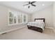 Bright bedroom with a ceiling fan, large window with plantation shutters, and plush carpeting at 2627 E Willamette Ln, Greenwood Village, CO 80121