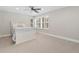 Bright bedroom with a white bed frame, a large window with plantation shutters, and neutral carpeting at 2627 E Willamette Ln, Greenwood Village, CO 80121