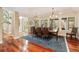 Elegant dining room with large windows, hardwood floors, and a stylish chandelier at 2627 E Willamette Ln, Greenwood Village, CO 80121