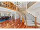Open foyer with staircase, hardwood floors, library, and dining room at 2627 E Willamette Ln, Greenwood Village, CO 80121