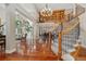Elegant foyer featuring a grand staircase, hardwood floors, and a view of the living spaces at 2627 E Willamette Ln, Greenwood Village, CO 80121