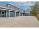 Multi-car garage with concrete driveway and lush landscaping at 2627 E Willamette Ln, Greenwood Village, CO 80121