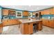 Spacious kitchen with a large island, custom cabinets, and stainless steel appliances at 2627 E Willamette Ln, Greenwood Village, CO 80121
