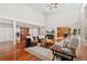 Spacious living room features wood floors, neutral paint, comfortable seating, and view to the kitchen at 2627 E Willamette Ln, Greenwood Village, CO 80121