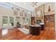 Inviting living room with a stone fireplace, hardwood floors, and natural lighting at 2627 E Willamette Ln, Greenwood Village, CO 80121