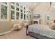 Bright main bedroom features a stone fireplace, sitting area, large windows, and cozy neutral tones at 2627 E Willamette Ln, Greenwood Village, CO 80121