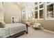 Large main bedroom with natural light, cozy sitting area, ensuite access, and neutral color palette at 2627 E Willamette Ln, Greenwood Village, CO 80121
