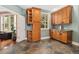 Mud room with slate floors, wooden cabinets, countertops, and a window offering natural light at 2627 E Willamette Ln, Greenwood Village, CO 80121