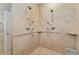 Luxurious tile shower featuring dual shower heads and multiple water outlets at 2627 E Willamette Ln, Greenwood Village, CO 80121