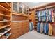 Spacious closet featuring built-in wood drawers, shelves, and hanging areas at 2627 E Willamette Ln, Greenwood Village, CO 80121