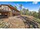 Backyard with a stone base and tall trees for shaded enjoyment at 34 Normandy Rd, Evergreen, CO 80439