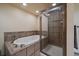 Elegant bathroom showcases a shower with glass door and soaking tub for relaxation at 34 Normandy Rd, Evergreen, CO 80439