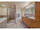 Bathroom featuring a glass-enclosed shower, soaking tub, and a stylish vanity with a vessel sink at 34 Normandy Rd, Evergreen, CO 80439
