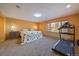 Bright bedroom with a large window, treadmill, and a cozy bed with a unique bear-themed comforter at 34 Normandy Rd, Evergreen, CO 80439