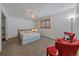 Neutral bedroom with a ceiling fan, two red chairs, a wood frame bed, and a closet with shelving at 34 Normandy Rd, Evergreen, CO 80439