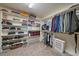 Well-organized walk-in closet with shelving, hanging rods, and ample storage space for clothes and accessories at 34 Normandy Rd, Evergreen, CO 80439