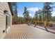 Expansive deck perfect for outdoor entertaining with views of the surrounding trees at 34 Normandy Rd, Evergreen, CO 80439