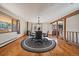 Sunny dining room with a wood burning stove, wood floors, a table with four chairs, and a view of the backyard at 34 Normandy Rd, Evergreen, CO 80439