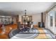Open dining room with a wood burning stove, wood floors, a table with chairs, and a view of the backyard at 34 Normandy Rd, Evergreen, CO 80439