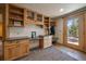 Convenient entryway features built-in cabinets, desk space, and easy access to the outdoors with a wood door at 34 Normandy Rd, Evergreen, CO 80439