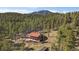 Secluded home with deck, set amidst a dense forest, offers privacy and scenic views at 34 Normandy Rd, Evergreen, CO 80439