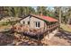 This exterior deck features black railings and an orange trim overlooking forest views at 34 Normandy Rd, Evergreen, CO 80439