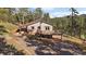 Charming mountain home with a spacious deck and beautiful views of the surrounding forest at 34 Normandy Rd, Evergreen, CO 80439