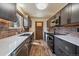 Modern kitchen with gray cabinets, brick backsplash, and stainless steel appliances at 34 Normandy Rd, Evergreen, CO 80439