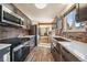 Bright kitchen features gray cabinets, stainless appliances, and wood flooring at 34 Normandy Rd, Evergreen, CO 80439