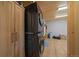 Functional laundry room features stacked washer and dryer, ample storage, and bright overhead lighting at 34 Normandy Rd, Evergreen, CO 80439