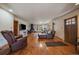 Bright living room with hardwood floors, fireplace, and comfortable seating area at 34 Normandy Rd, Evergreen, CO 80439