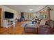 Spacious living room with wood floors, leather sofa, and unique fireplace at 34 Normandy Rd, Evergreen, CO 80439