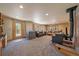 Cozy living room with lots of natural light, a wood burning stove, and two couches at 34 Normandy Rd, Evergreen, CO 80439