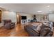 Inviting living room featuring hardwood floors, fireplace, and a comfortable leather sofa and recliner at 34 Normandy Rd, Evergreen, CO 80439
