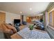 Cozy living room with wood-burning stove, plush leather seating, and natural light from the window at 34 Normandy Rd, Evergreen, CO 80439