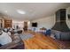 Open-concept living room with hardwood floors and a cozy fireplace perfect for gatherings at 34 Normandy Rd, Evergreen, CO 80439