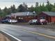 Charming log cabin with inviting string lights and parking for multiple vehicles at 184 Signal Rock Rd, Golden, CO 80403