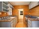 Kitchen with wood paneled walls, wooden floors, light-blue cabinets, and tile countertops at 184 Signal Rock Rd, Golden, CO 80403