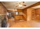 Open concept living room with wood paneled walls, hardwood floors, and breakfast bar at 184 Signal Rock Rd, Golden, CO 80403