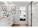 Modern bathroom boasts dual vanity with a quartz countertop, black hardware and a sleek glass shower with black trim at 1415 Orchard St, Brighton, CO 80601