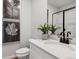 Stylish powder room features modern fixtures, elegant decor, and a sleek, glass-enclosed shower at 1415 Orchard St, Brighton, CO 80601
