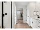 Bright bathroom featuring a glass-enclosed shower, wood-look floors and a white vanity with countertop space at 1415 Orchard St, Brighton, CO 80601