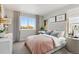 Bright bedroom featuring a large window with outdoor views, plush bedding and elegant decor at 1415 Orchard St, Brighton, CO 80601